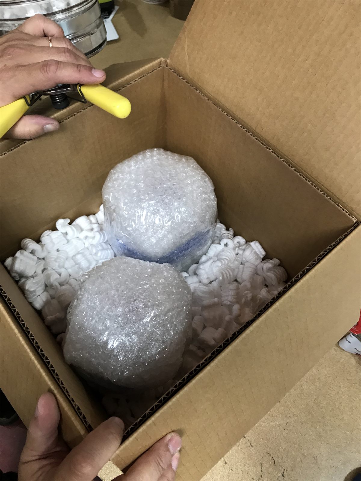 Bubble-wrapped fragile items cushioned inside a shipping box