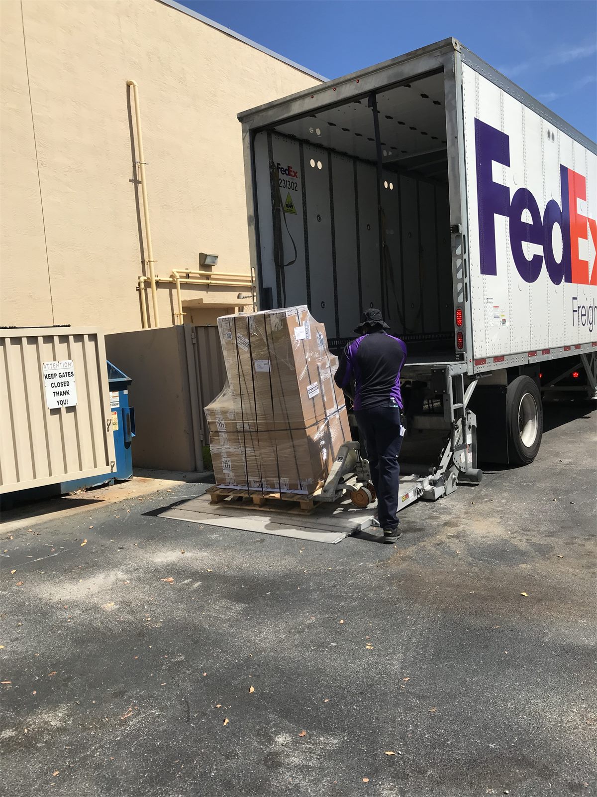 Palletized freight shipment being picked up for carrier transport