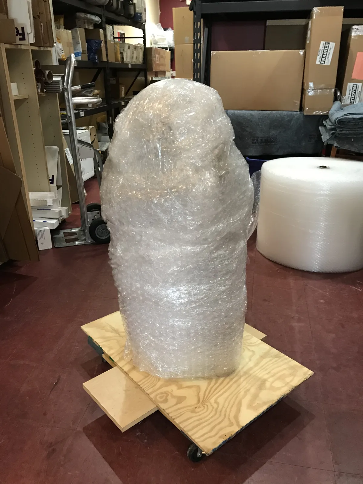 Fragile sculpture fully wrapped and supported on a base