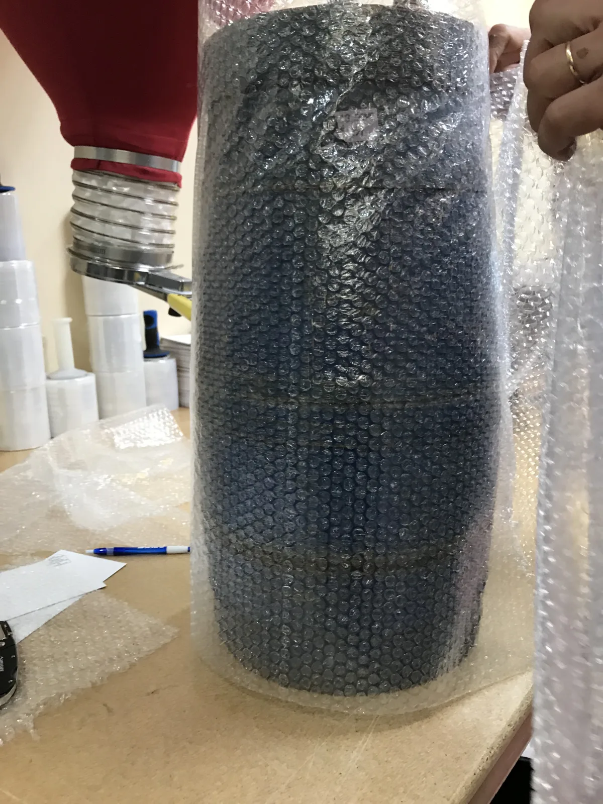 Tall fragile vessel wrapped with layered bubble protection
