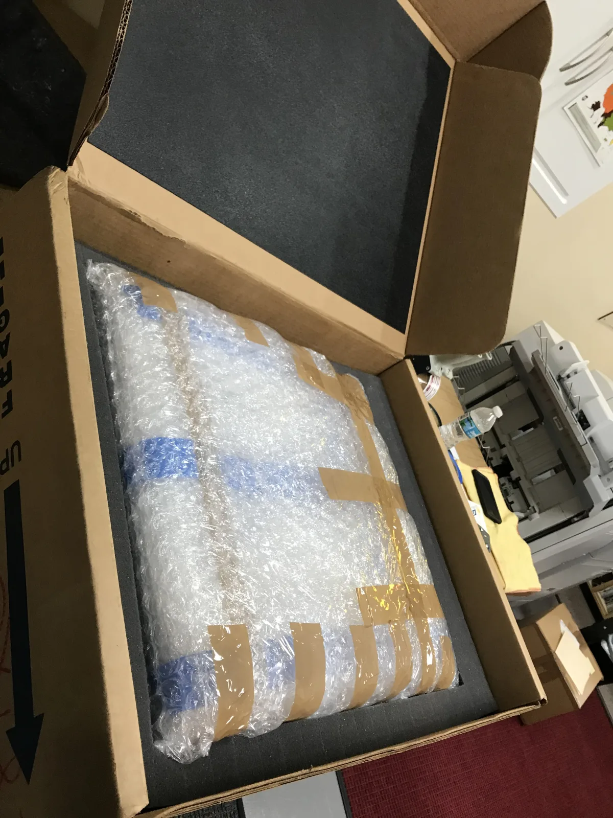 Protected framed artwork fitted securely inside a shipping box