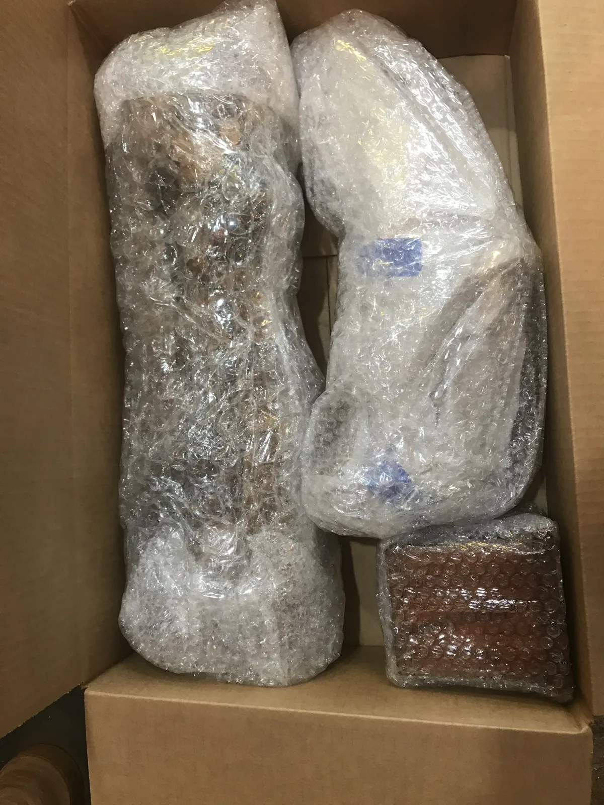 Several fragile items individually wrapped inside a carton