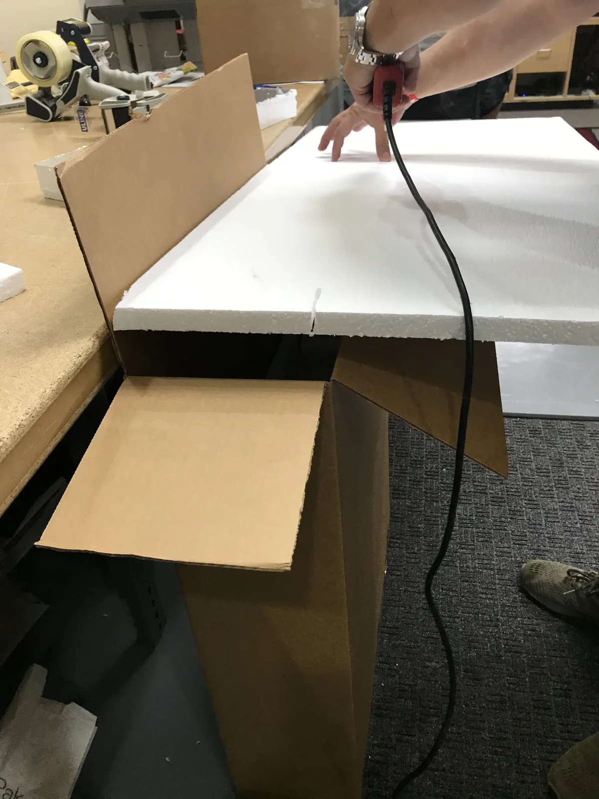 Custom foam being cut for a fitted carton