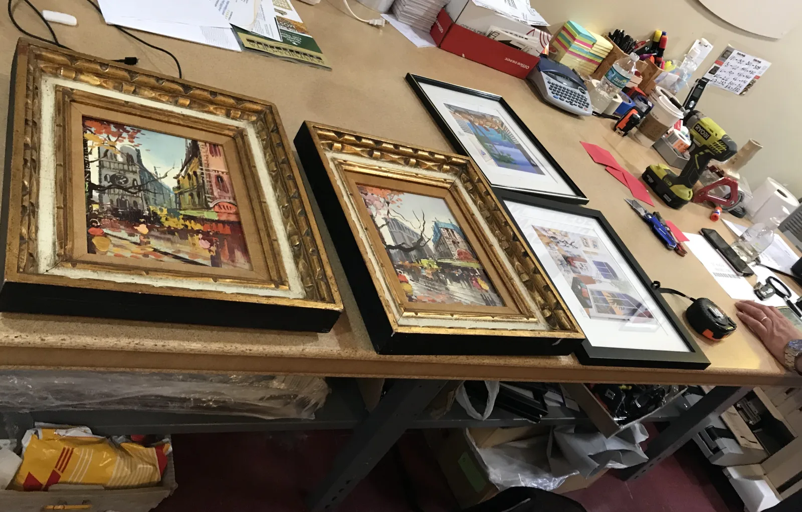 A collection of framed artwork before professional packing