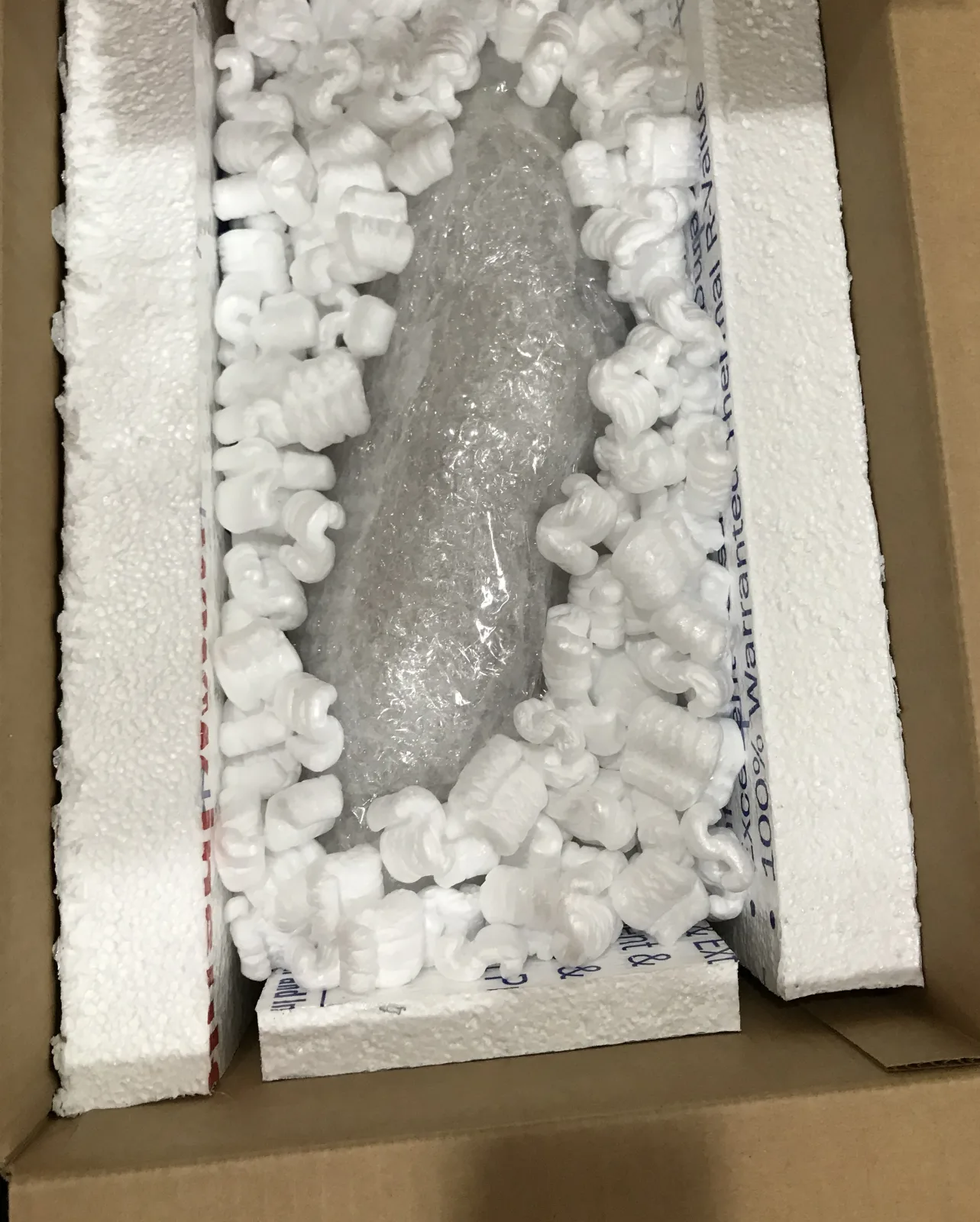 Fragile item fitted inside a foam-lined shipping box