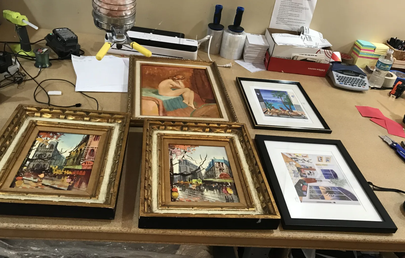 A varied collection of fragile framed pieces before packing