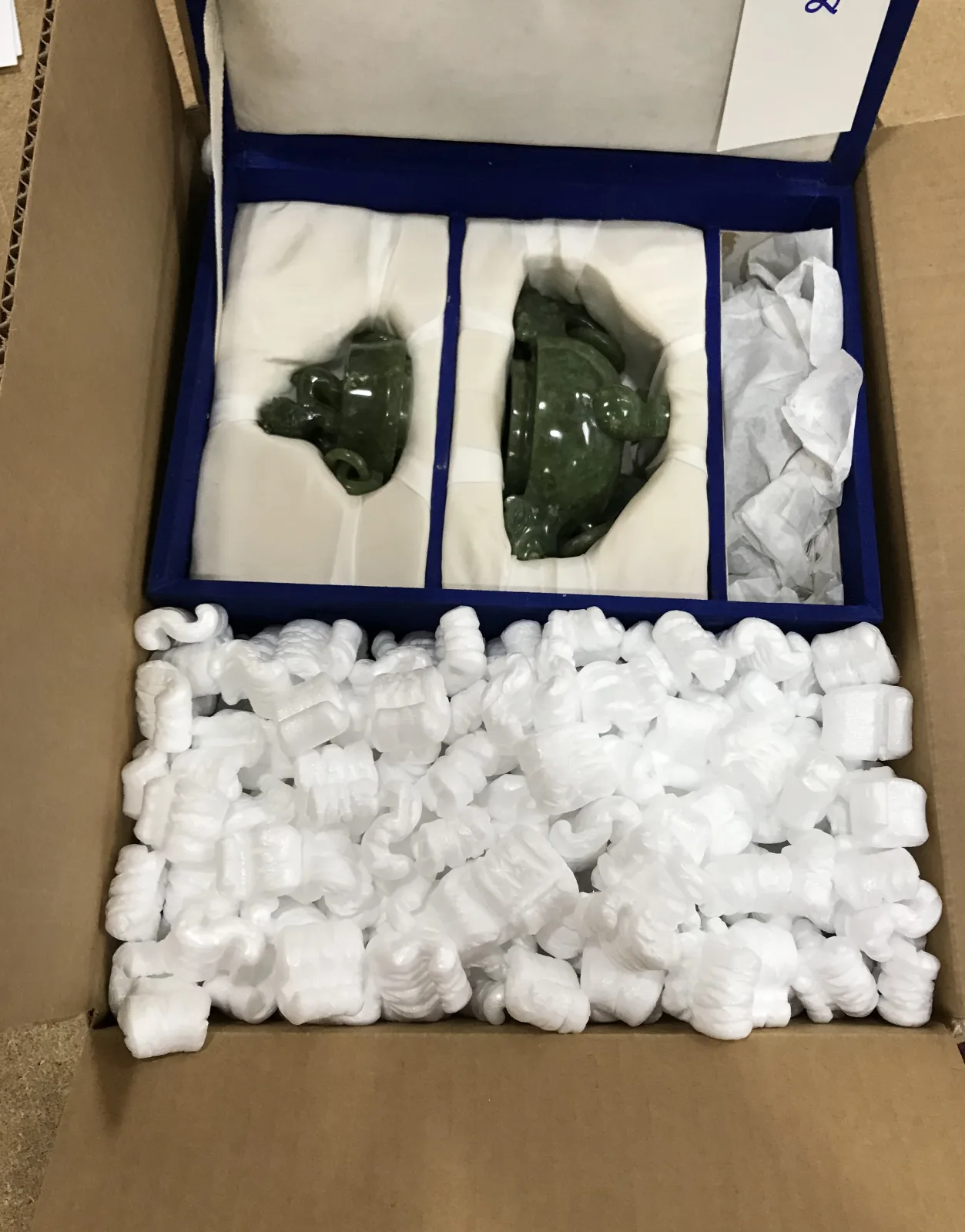 Fragile decorative pieces secured in fitted foam compartments