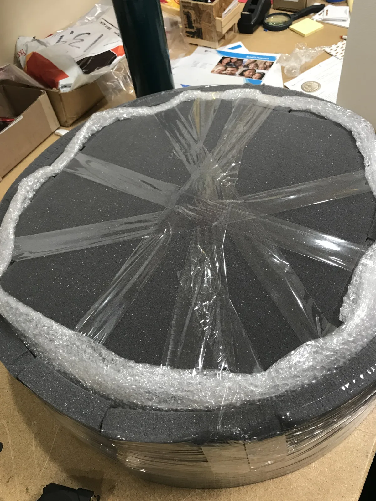 Large round item protected with layered wrap and edge cushioning