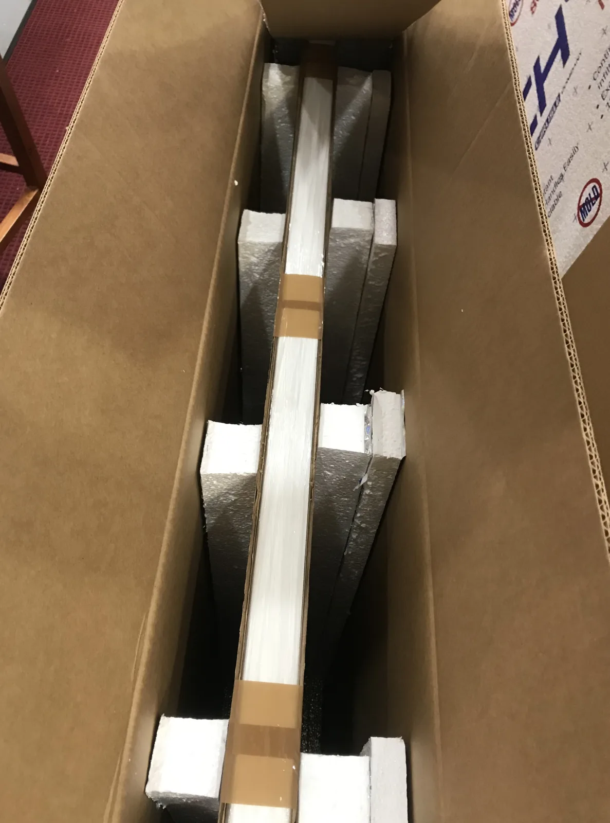 Framed pieces separated with foam inside a return-shipping carton