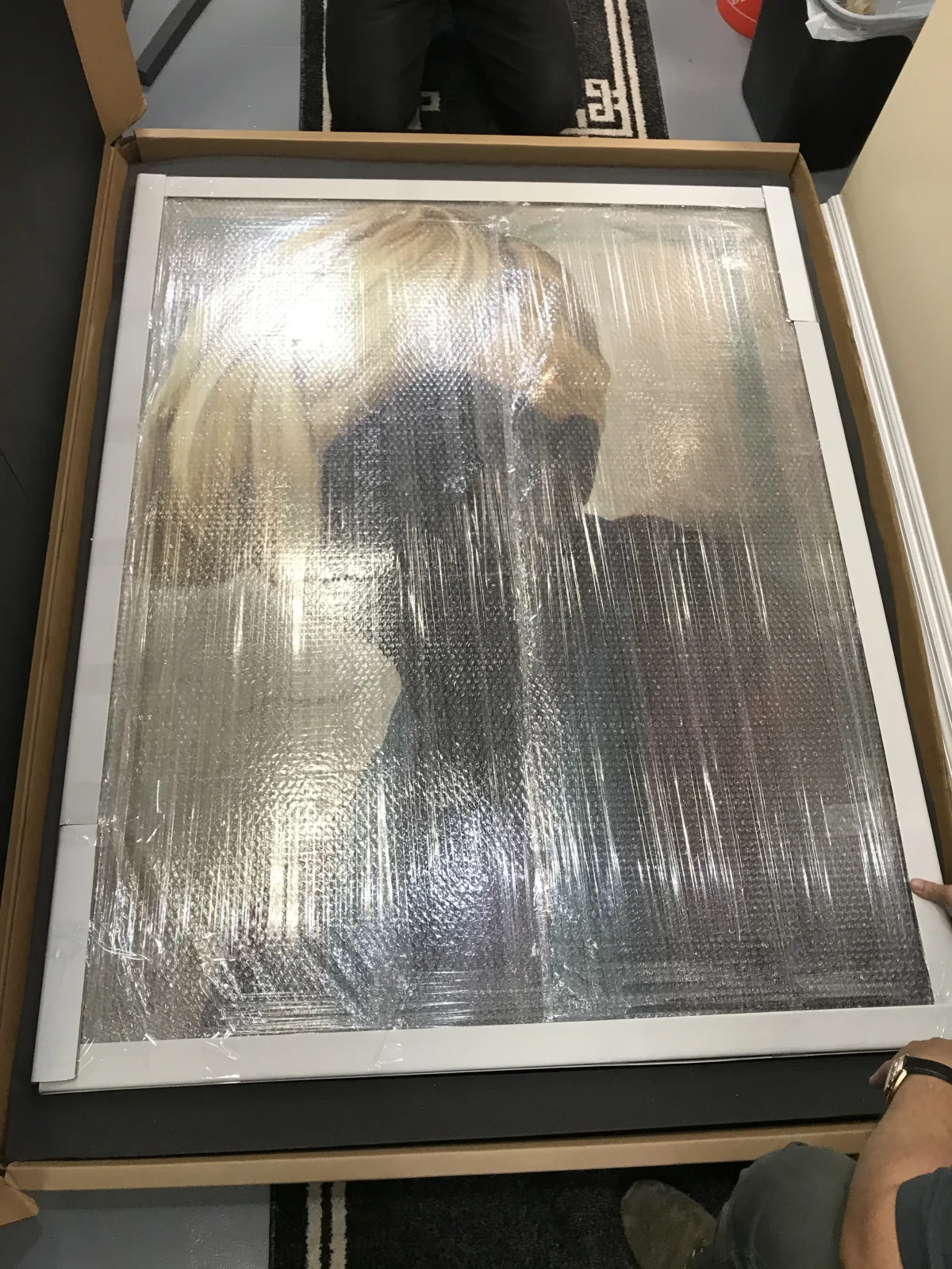 Framed artwork secured inside a fitted foam-lined carton